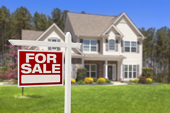 Home For Sale Real Estate Sign and Beautiful New House.