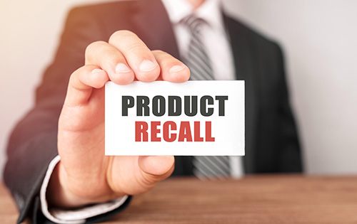 Businessman holding a card with text Product Recall